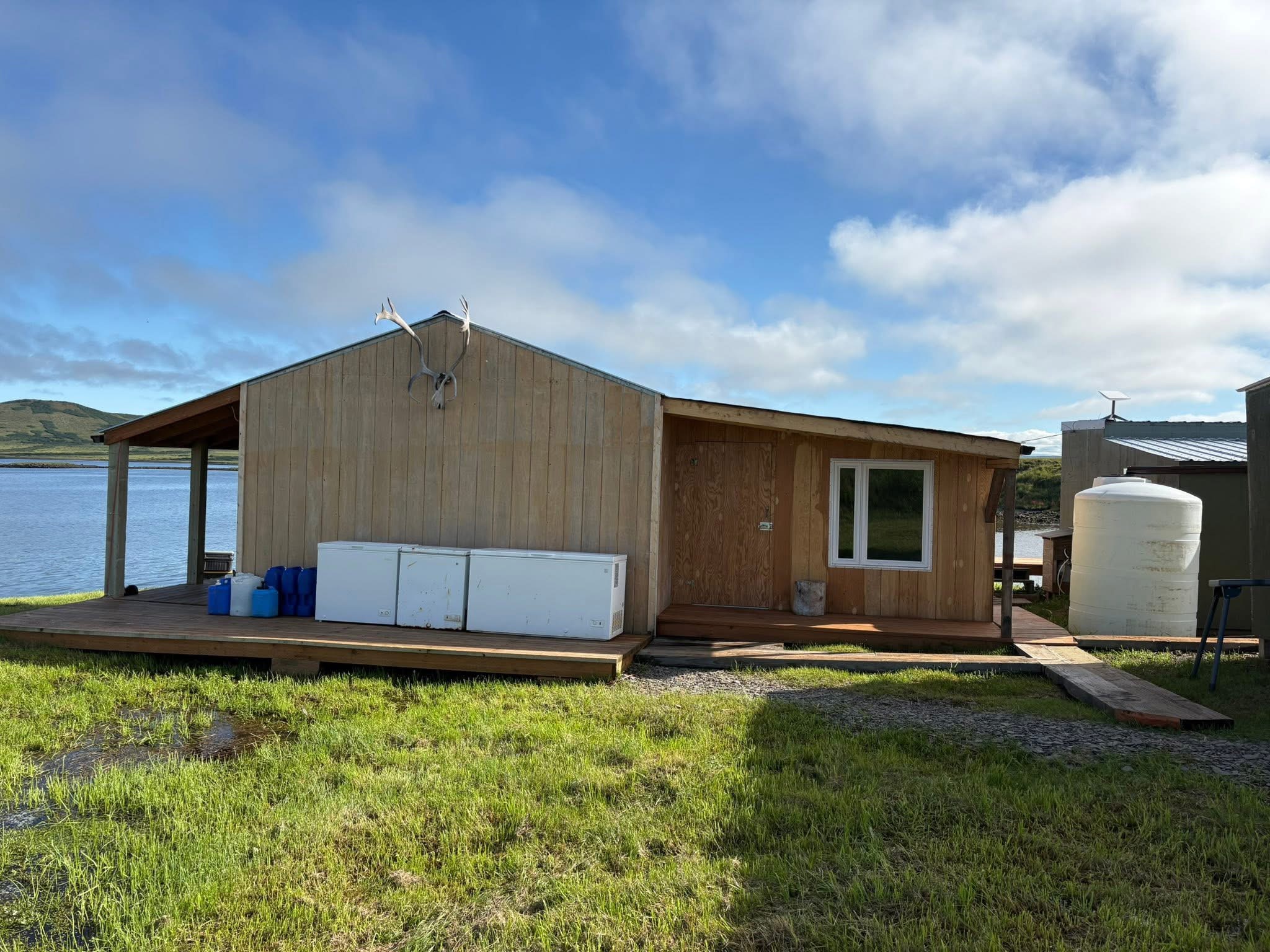 Wooden camp cabin beside the lake in daylight