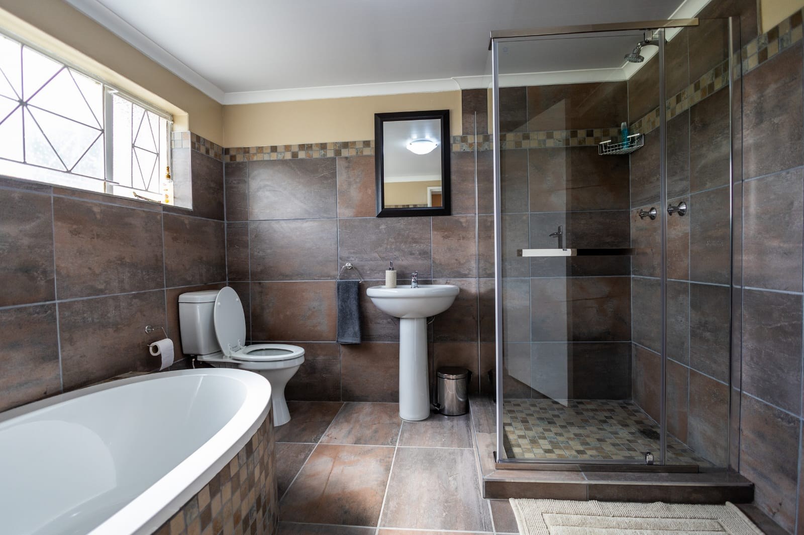Bathroom with a bathtub and glass shower